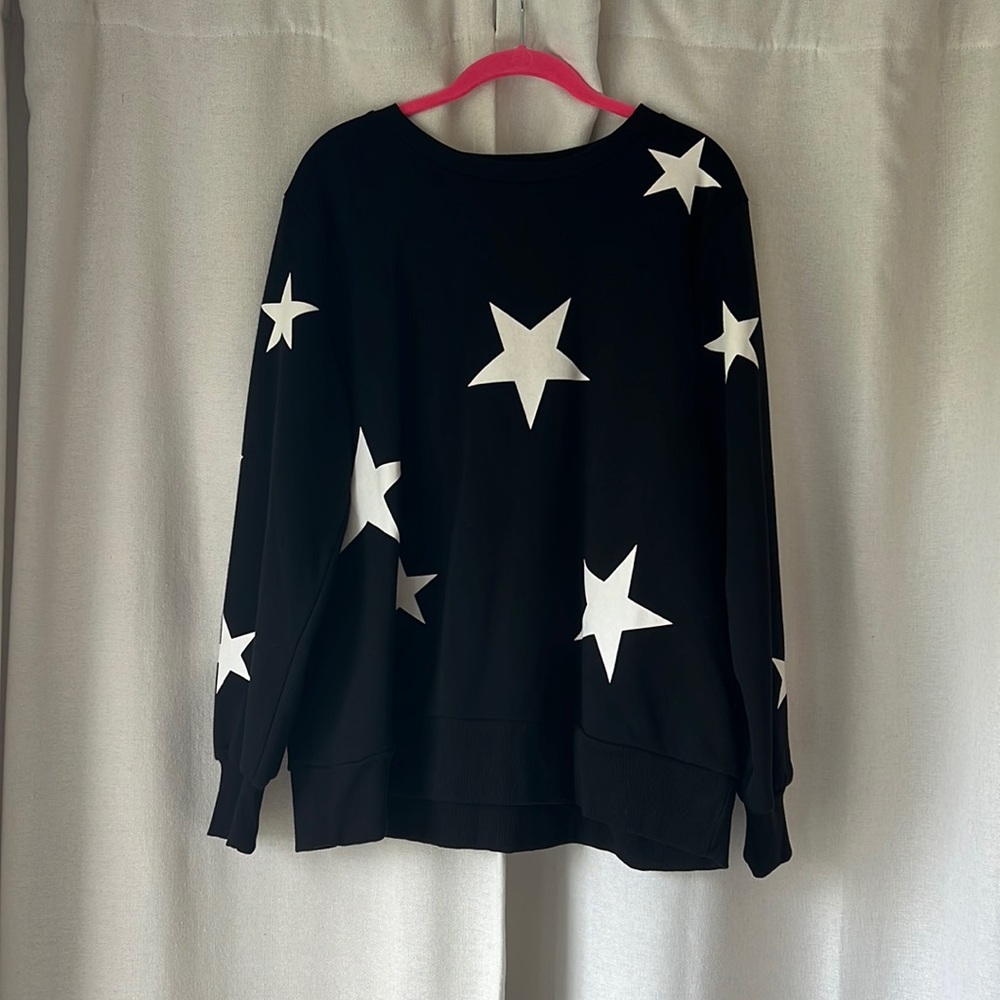 Umgee sweatshirt. Black with white start. New with tags. Runs slightly small.